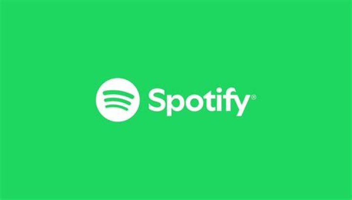 A Spotify logo on a black phone screen. 