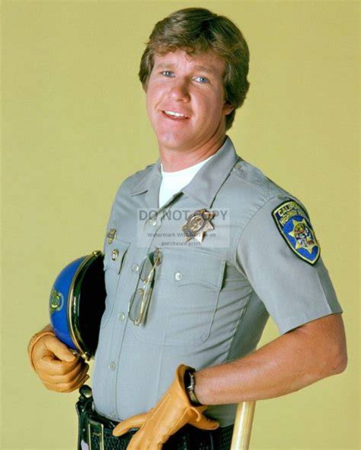 Larry Wilcox posing for a picture with his son and grandson.